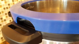 Close up of drain channel opening on blue silicone 6 quart model of Rim-O pressure cooker accessory covering rim of electric pressure cookers like the Instant Pot.