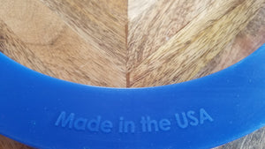 Close up top view of "Made in the USA" raised lettering on blue silicone 6 quart model of Instant Pot electric pressure cooker accessory cover.